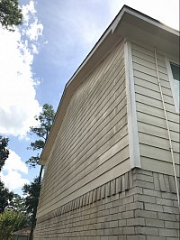 Mold on side of house to be removed by soft washing, pressure washing